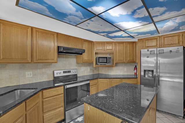 kitchen with extractor fan, appliances with stainless steel finishes, a center island, and dark stone counters