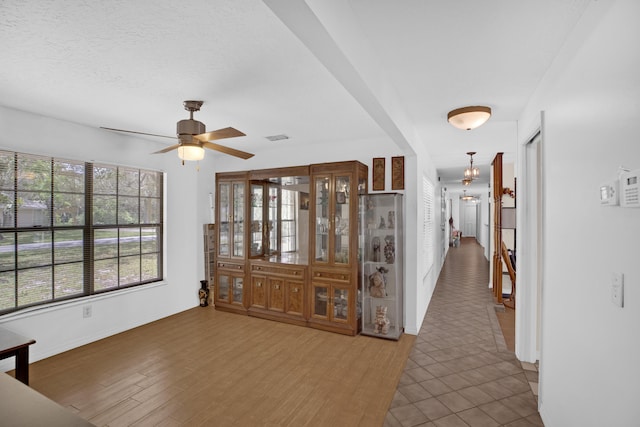 interior space featuring ceiling fan, dark hardwood / wood-style floors, and a textured ceiling