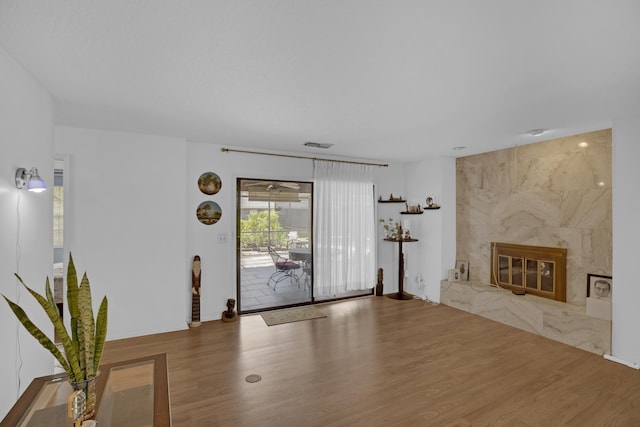 unfurnished living room featuring hardwood / wood-style floors and a premium fireplace