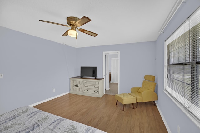 living area featuring ceiling fan and light hardwood / wood-style flooring