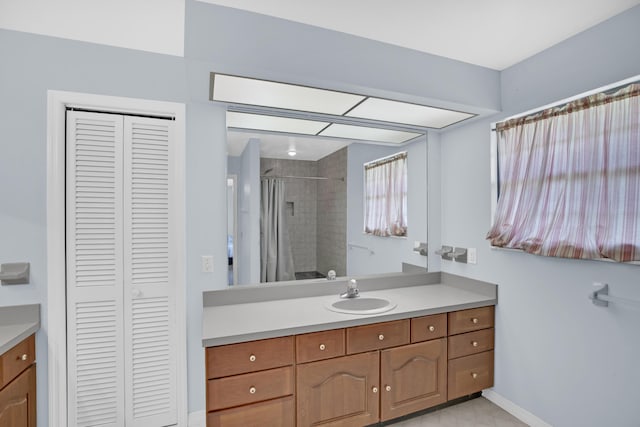 bathroom with vanity and tiled shower