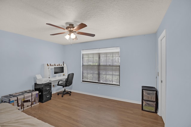 office space with ceiling fan, wood-type flooring, and a textured ceiling