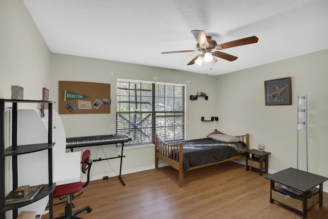 bedroom featuring hardwood / wood-style floors and ceiling fan