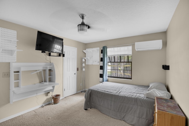 bedroom with carpet and a wall mounted air conditioner