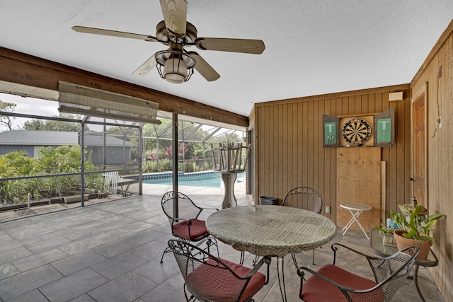 sunroom featuring ceiling fan