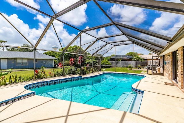 view of swimming pool featuring a patio area and glass enclosure