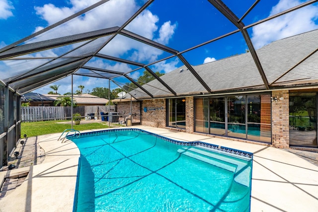 view of pool featuring a yard, a lanai, and a patio area