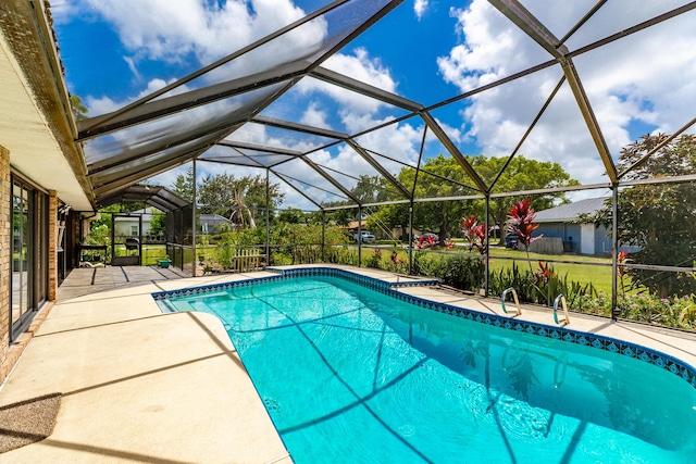 view of swimming pool featuring a patio and glass enclosure