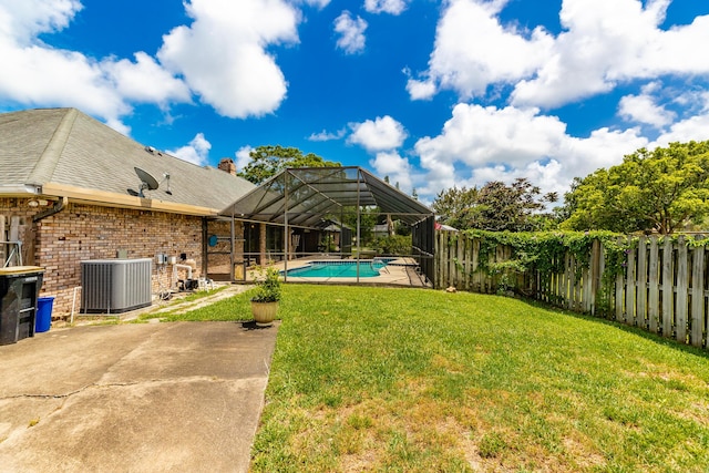 view of yard featuring a fenced in pool, a lanai, a patio area, and central air condition unit