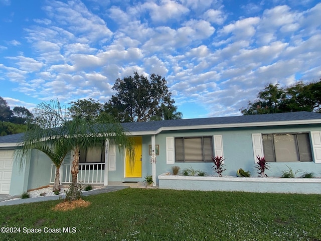 ranch-style house with covered porch and a front yard