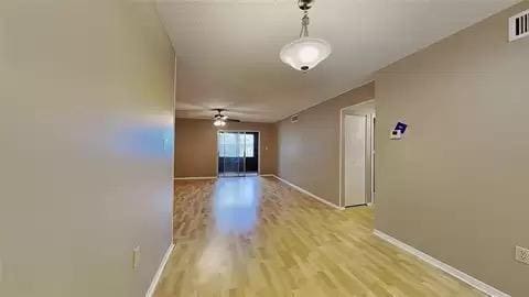 spare room featuring ceiling fan and light hardwood / wood-style flooring