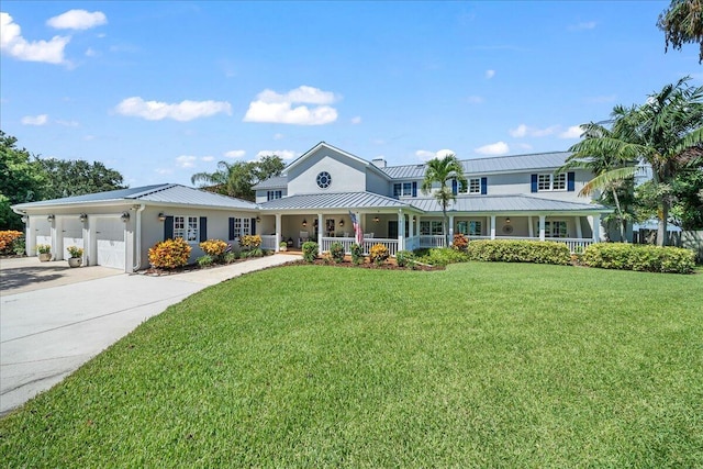 view of front of property with a porch, a garage, and a front lawn