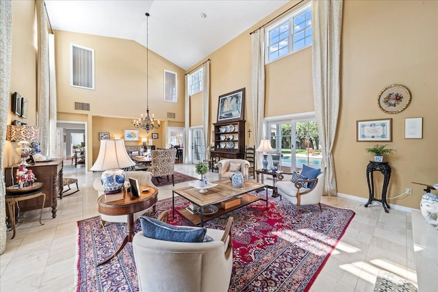 living room with a towering ceiling, light tile patterned flooring, and an inviting chandelier