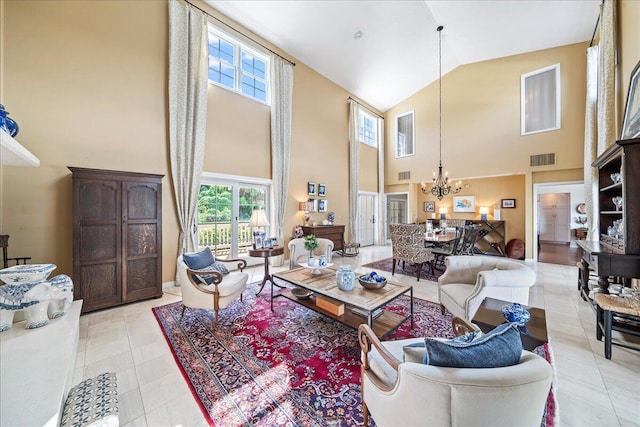 tiled living room featuring high vaulted ceiling and a chandelier