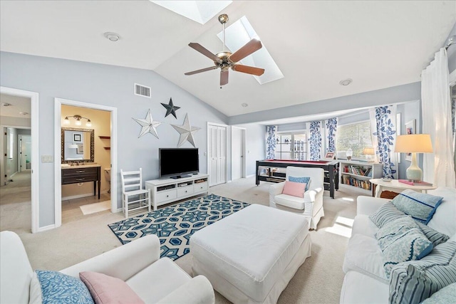 living room with ceiling fan, vaulted ceiling with skylight, light colored carpet, and billiards