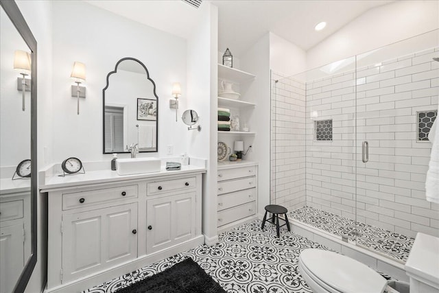 bathroom with tile patterned floors, vanity, lofted ceiling, toilet, and a shower with shower door