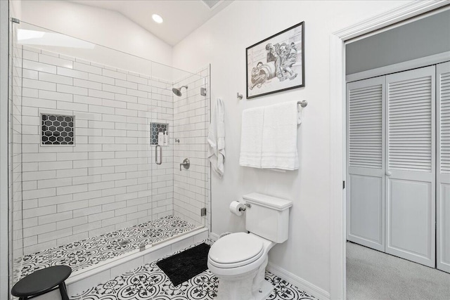 bathroom featuring toilet, an enclosed shower, and lofted ceiling