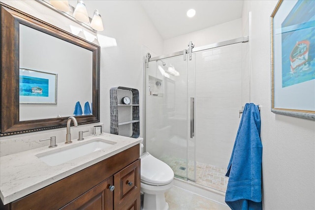 bathroom featuring vanity, toilet, walk in shower, and lofted ceiling