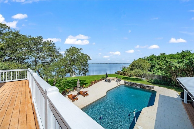 view of pool featuring a yard, a patio, and a water view