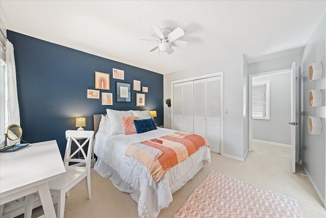 carpeted bedroom featuring a closet and ceiling fan