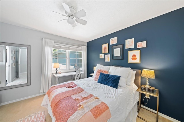 bedroom with ceiling fan and light carpet