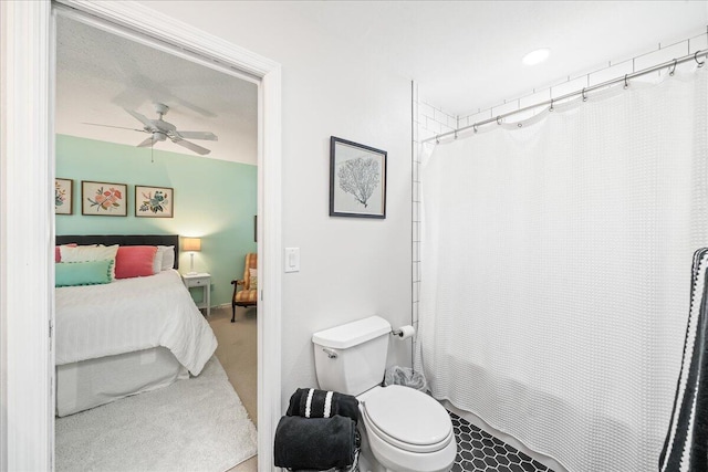 bathroom with shower / bath combination with curtain, toilet, and ceiling fan