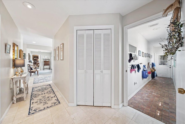 hallway with light tile patterned floors