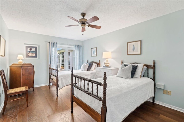 bedroom with ceiling fan, dark hardwood / wood-style floors, and a textured ceiling