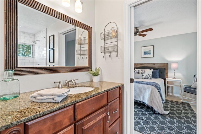 bathroom featuring ceiling fan and vanity