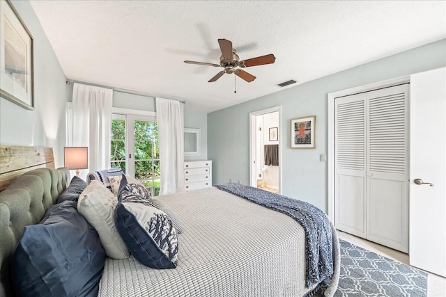 bedroom featuring ceiling fan, a textured ceiling, and a closet