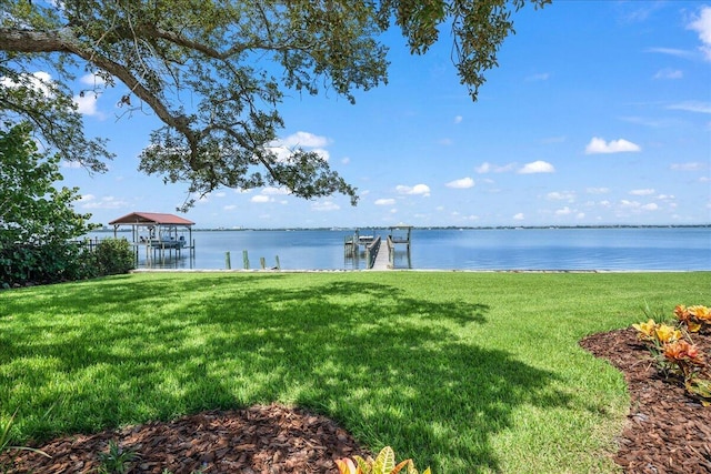 view of yard featuring a water view and a dock