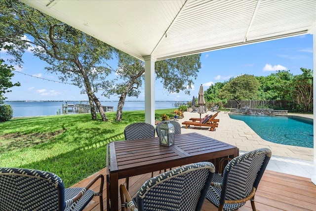 exterior space with a lawn, a water view, and a patio