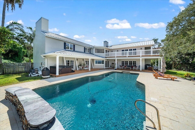 view of pool with a patio and a hot tub