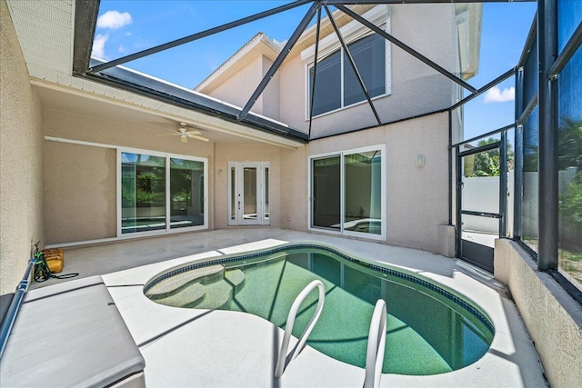 view of swimming pool with a patio, ceiling fan, and a lanai