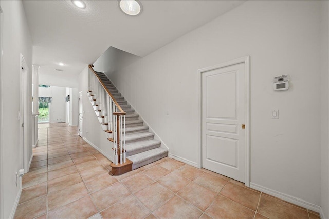 stairway featuring tile patterned floors