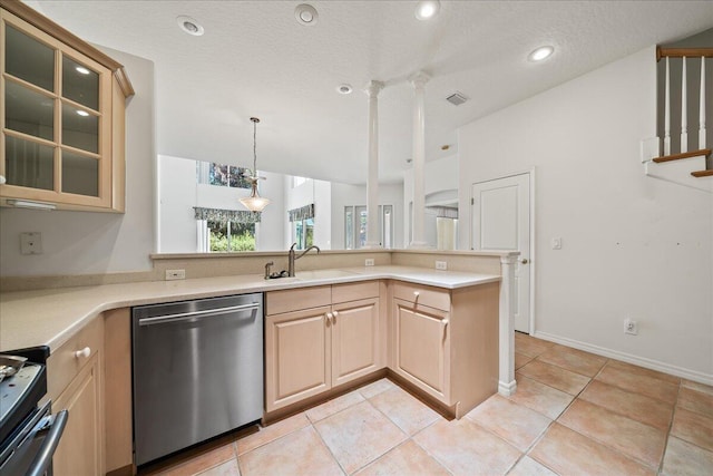 kitchen with sink, a textured ceiling, light brown cabinetry, appliances with stainless steel finishes, and kitchen peninsula