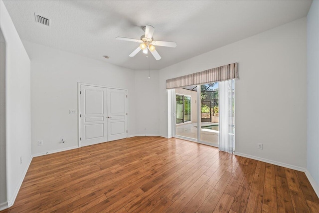 unfurnished room featuring ceiling fan, a textured ceiling, and hardwood / wood-style flooring