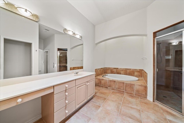 bathroom featuring tile patterned flooring, vanity, and separate shower and tub