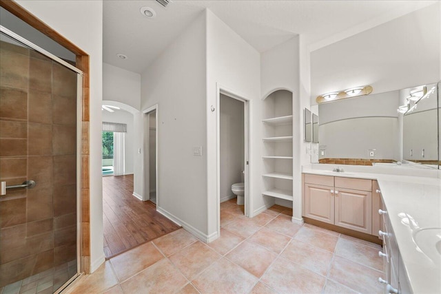 bathroom with tile patterned floors, vanity, built in features, and walk in shower