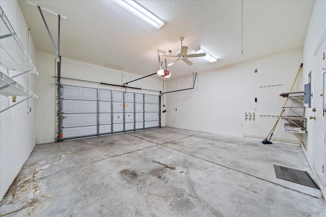 garage with a garage door opener and ceiling fan