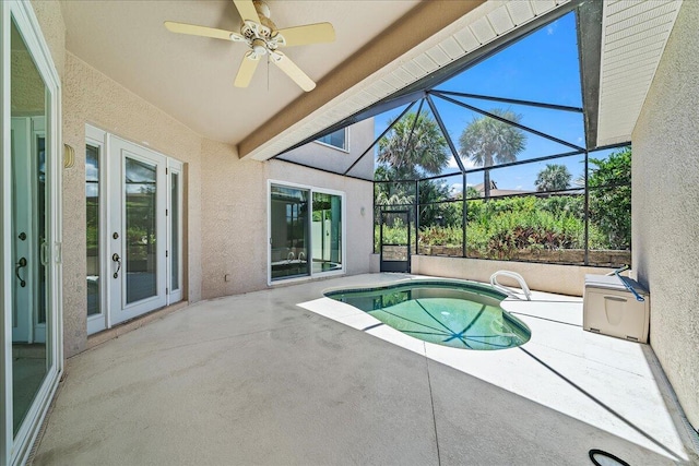 view of swimming pool featuring french doors, glass enclosure, ceiling fan, and a patio area