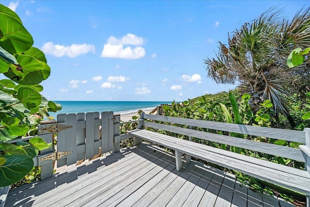 deck with a water view and a view of the beach