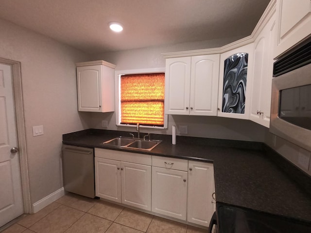 kitchen featuring white cabinetry, sink, light tile floors, and stainless steel appliances