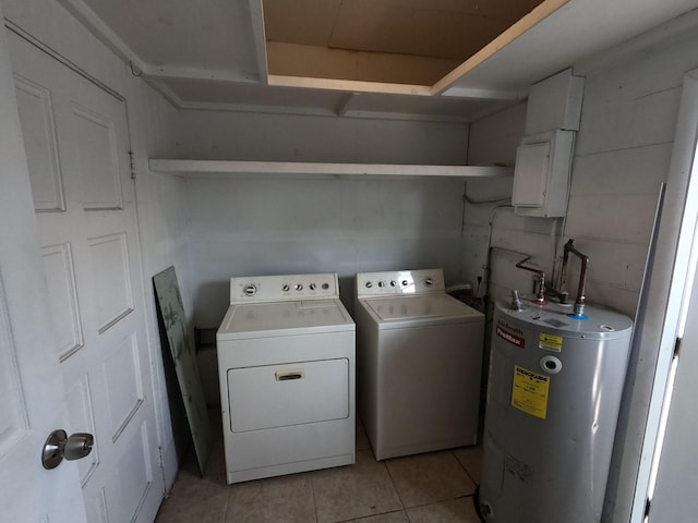 clothes washing area with washer and clothes dryer, gas water heater, and light tile floors