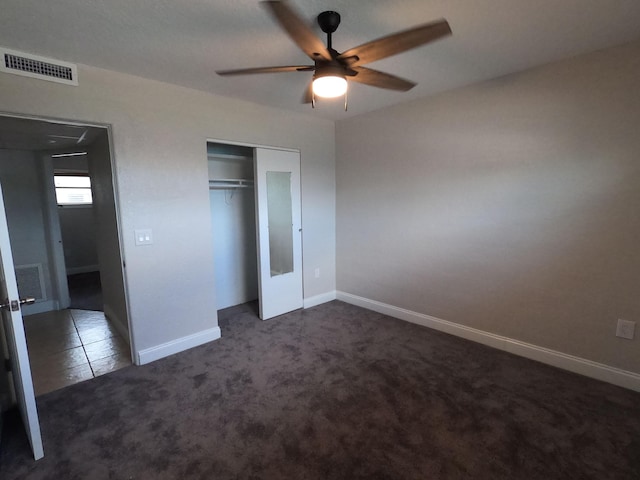 unfurnished bedroom with carpet, a closet, and ceiling fan