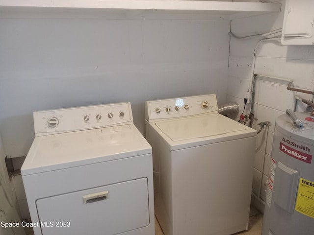 washroom with washer and dryer and electric water heater