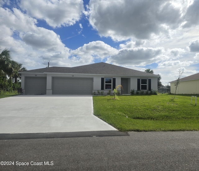 ranch-style house with stucco siding, driveway, a front yard, and a garage