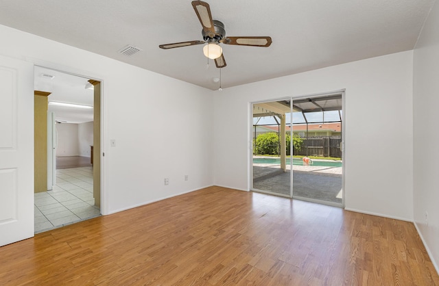 unfurnished room featuring ceiling fan and light hardwood / wood-style flooring