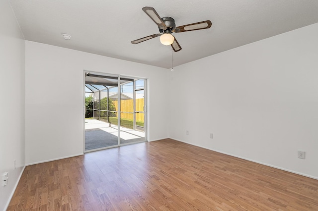 spare room featuring ceiling fan and light hardwood / wood-style floors