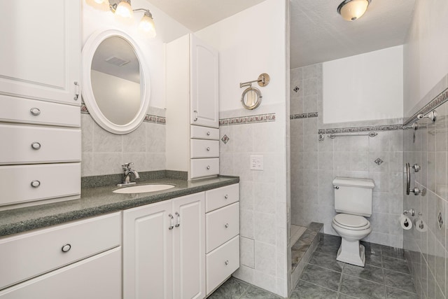 bathroom featuring tile walls, tile patterned flooring, vanity, and toilet